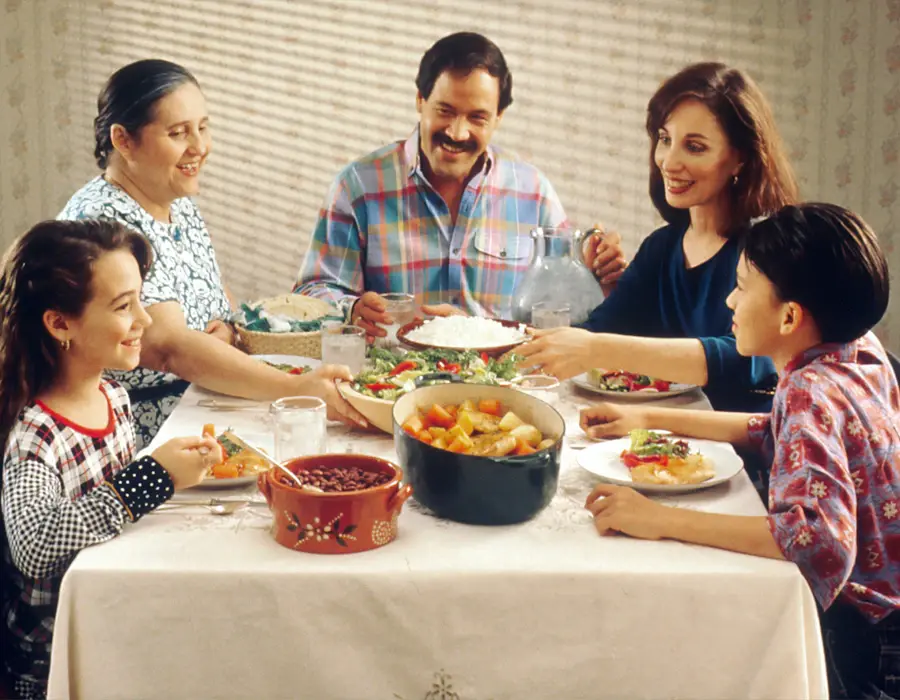 A family sharing dinner together, phones nowhere at the table