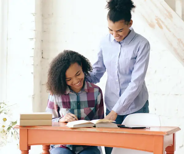 Two people studying side by side